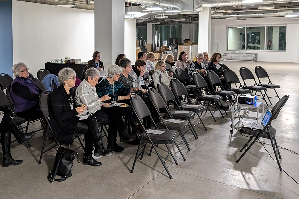 Pictured: She Shares members listen to presentations from hospital staff at December funding meeting